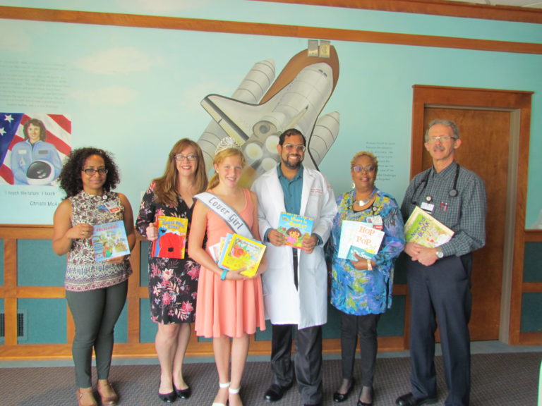Charlotte Olson (center) once again collected books to benefit young patients at Cooper.  Cooper staff was on hand to accept the donation (left to right): Ivette Martinez, APN; social worker Ellen Hearon; social worker Toni Mathis; pediatrician M. Jawaad Hussain, MD, FAAP; and pediatrician Scott L. Kiehlmeier, MD.