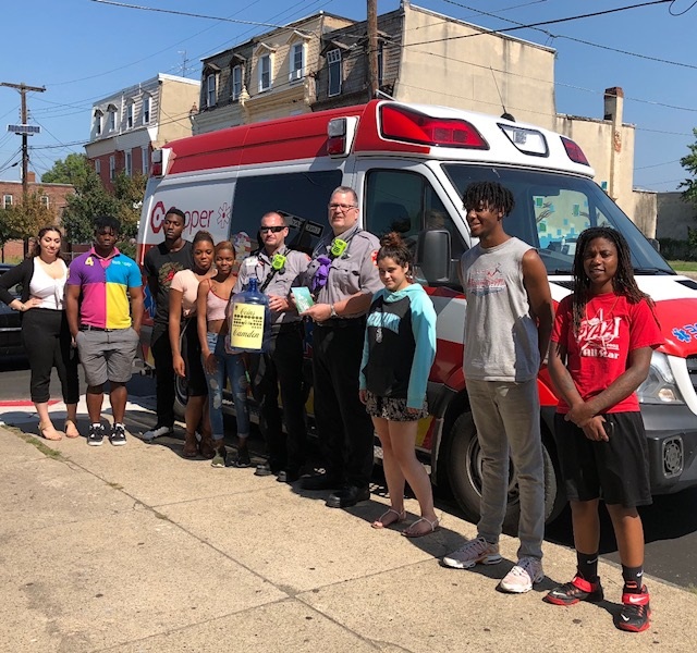 EMTs Zach Ewan and Charlie Brown are shown with student interns in front of Hopeworks N Camden offices on State Street in Camden, NJ.