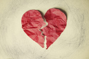 Heart form in red on a crumpled paper background