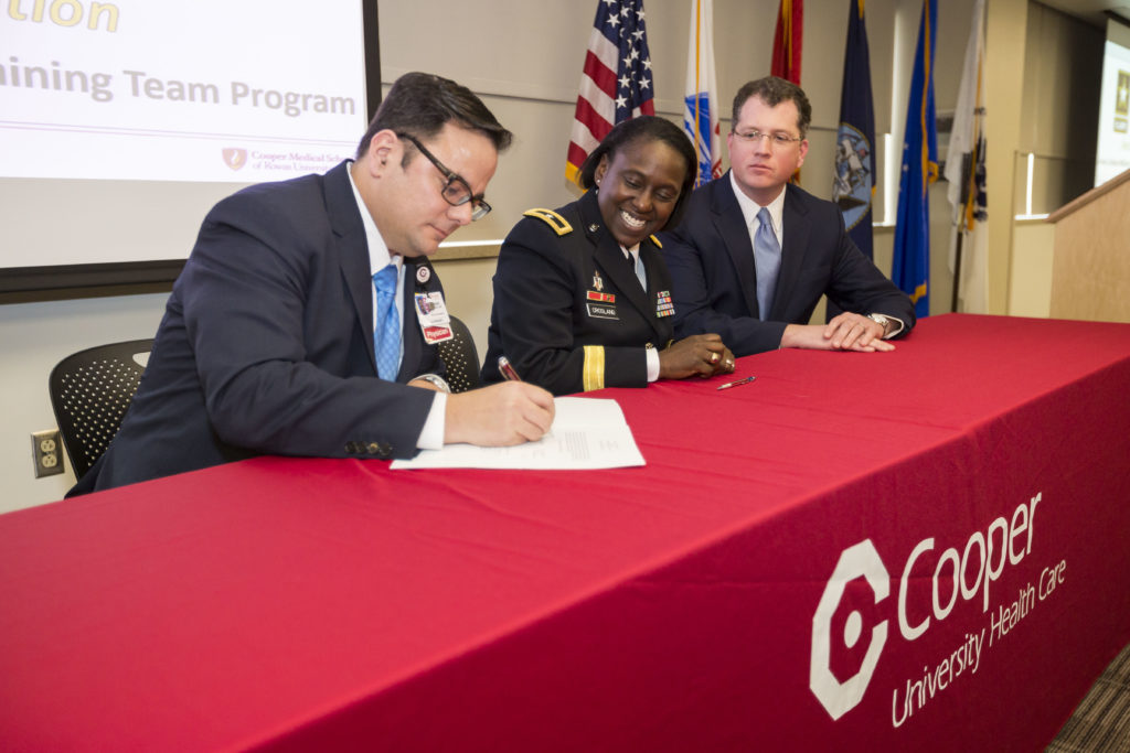 Anthony J. Mazzarelli, MD, JD, Co-President, Cooper University Health Care signs agreement with Brig. Gen. Telita Crosland, commanding general, Regional Health Command-Atlantic; and Kevin O’Dowd, JD, Co-President Cooper University Health Care.