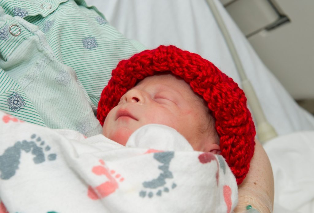 Each baby born at Cooper in February will receive a cozy, handmade red hat.