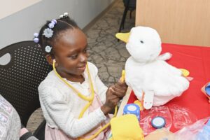 Four-year-old Eva Dey gives her My Special Aflac Duck a check-up.