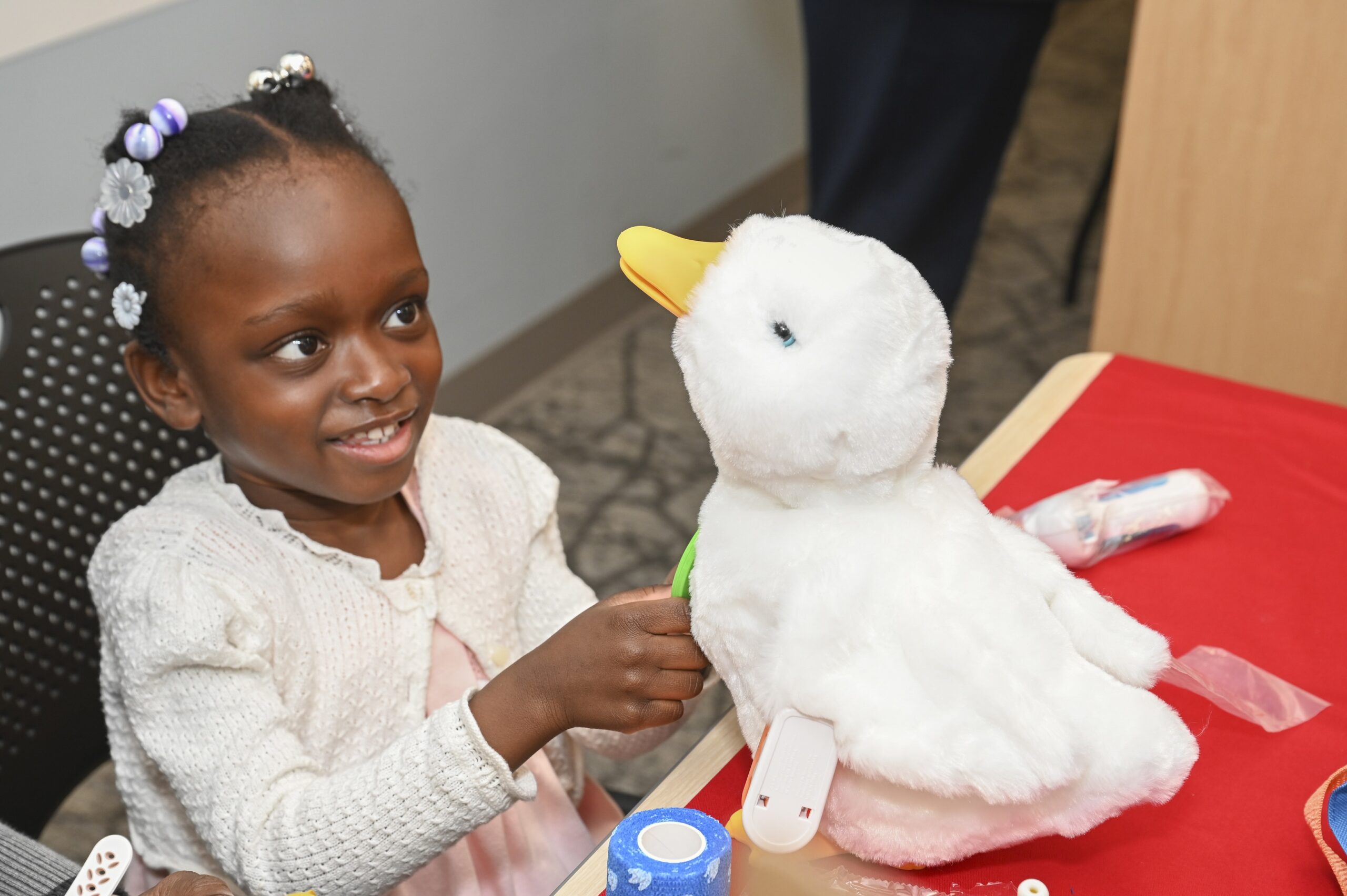Four year old Eva Dey plays with her My Special Aflac Duck, who she has named Larry.