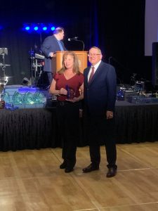 Tracy accepts her award from David Adinaro, MD, Deputy Commissioner, New Jersey Department of Health, Public Health Services.